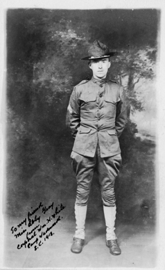 a black and white photograph of a soldier standing at attention