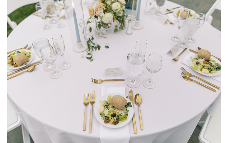 A simple table setting on a round white tablecloth