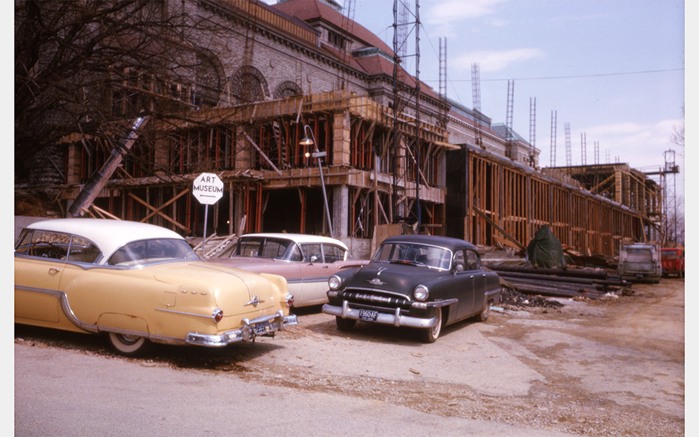 A historical color photo of the Adams-Emery wing under construction, with wooden framing