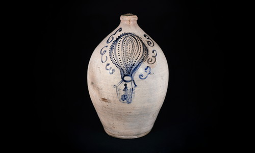 A ceramic jar with a hot air balloon decoration