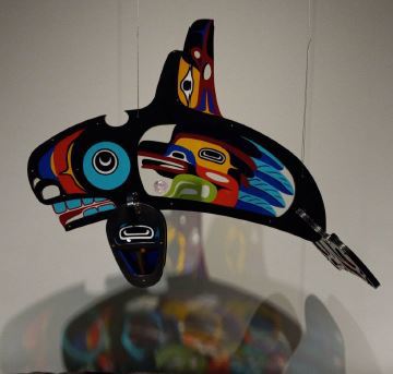 Mystical Journey Prototype is a three-dimensional sculpture created from fused and cast glass and aluminum. This sculpture is in the form of an orca or killer whale.