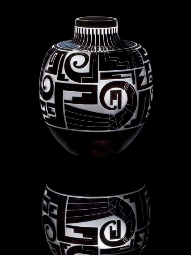 A dark black and white vase with geometric patterns