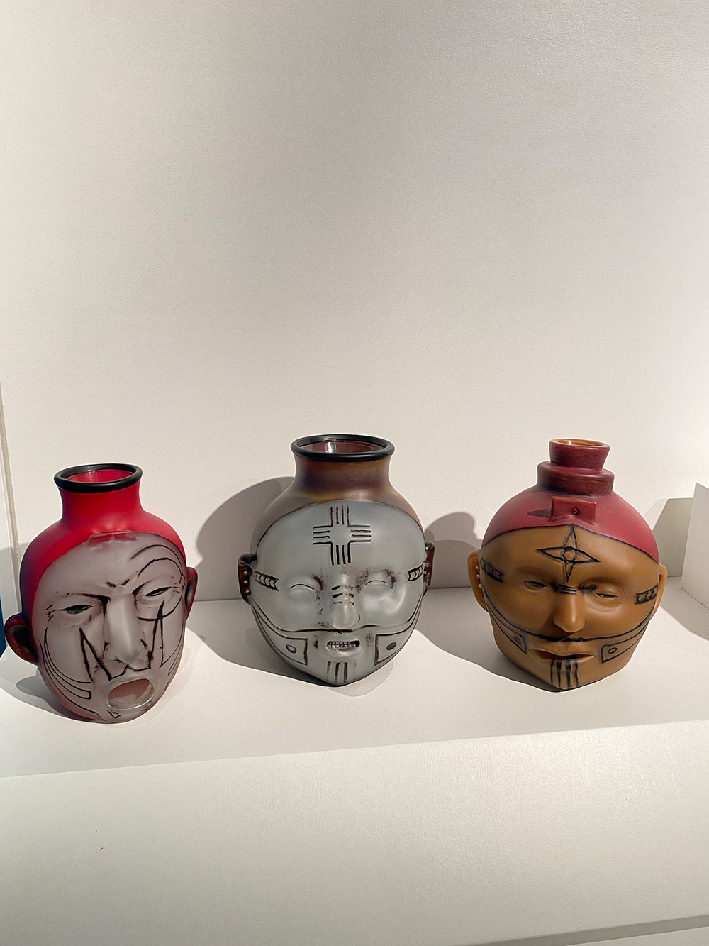 Three vases withi faces on them