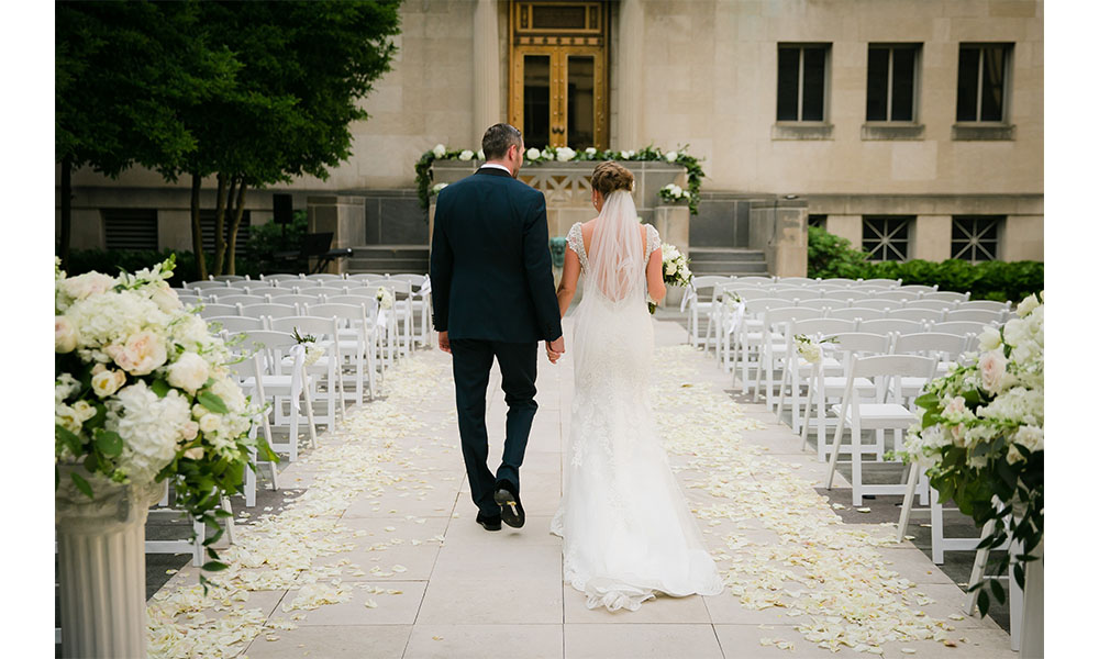 bride and groom walking down the aisle in the Alice Bimel courtyard