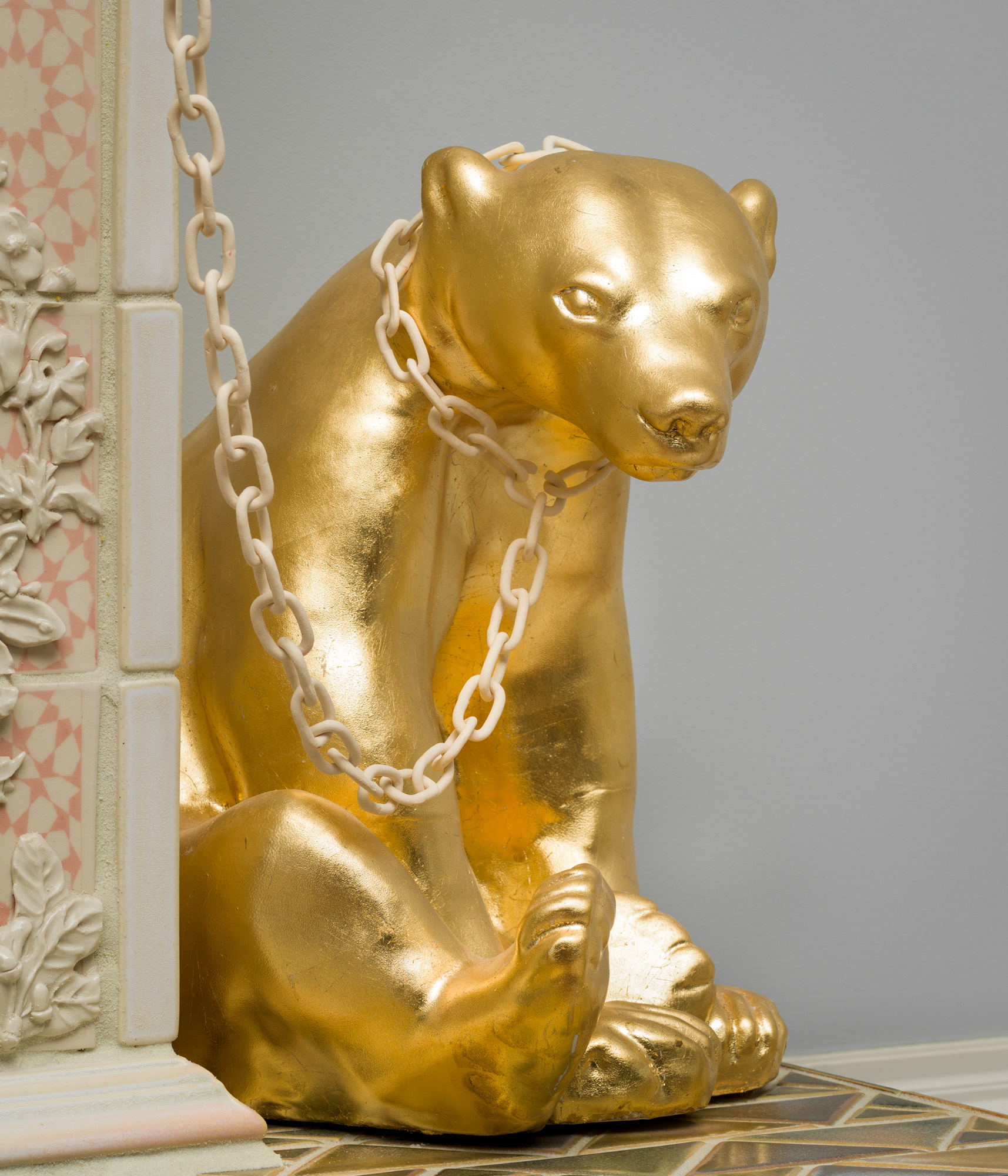 one of the golden bears with a chain around its neck sitting on the right side