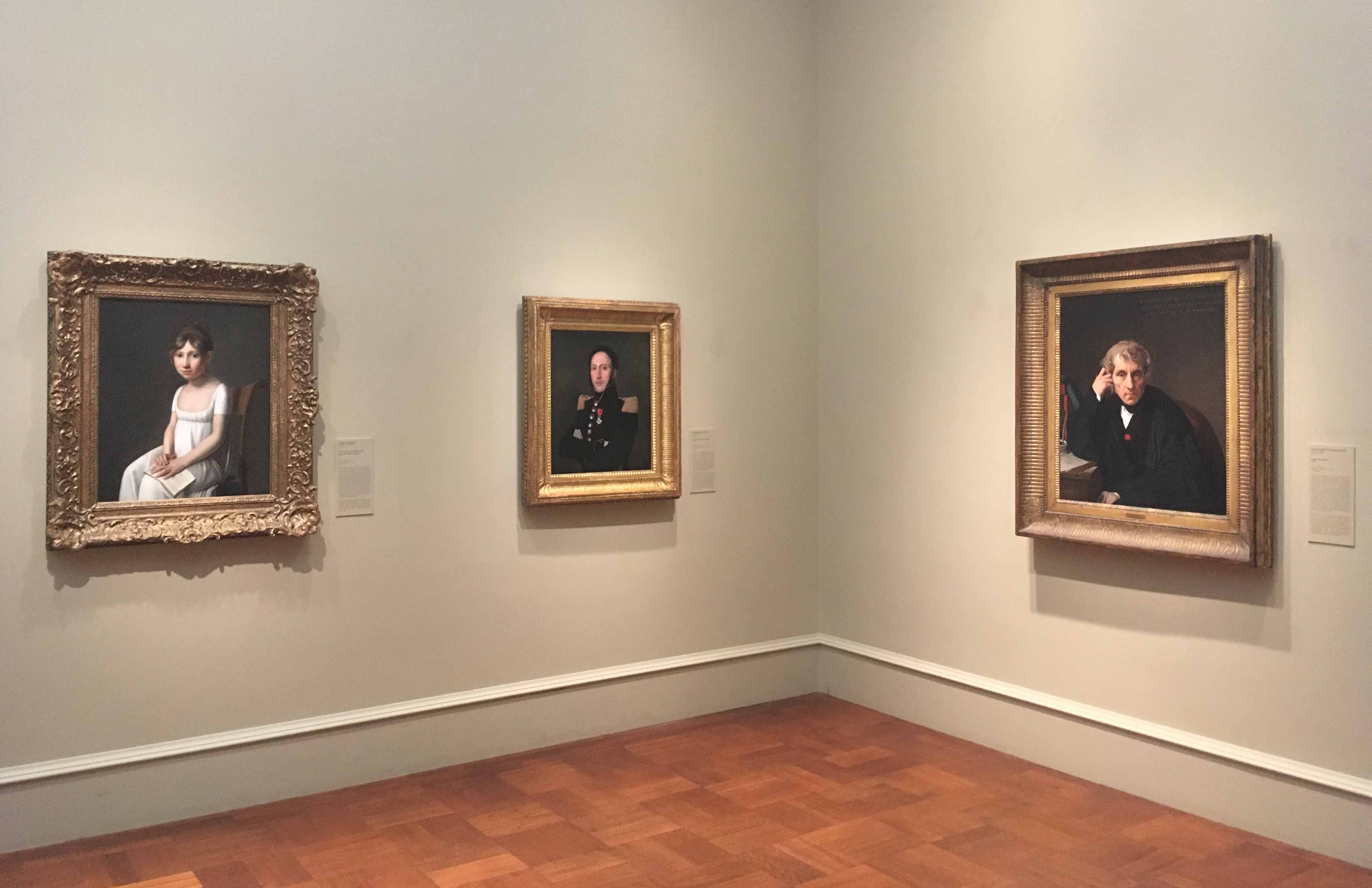 the three paintings hung in an exhibit