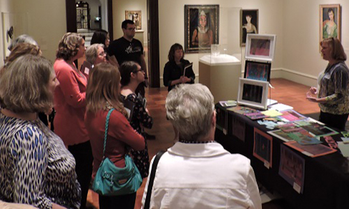 teachers receiving a lecture in a gallery