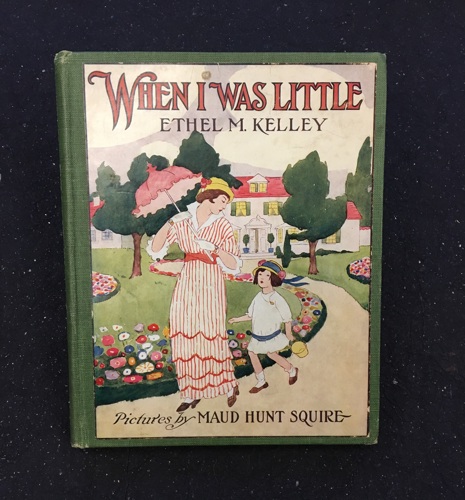 cover of When I Was Little depicting a woman and a girl walking along a path lined by flowers infront of their home
