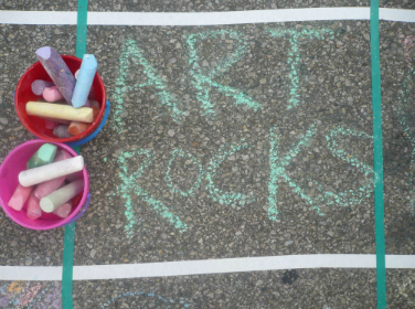 Arts Rocks written in sidewalk chalk