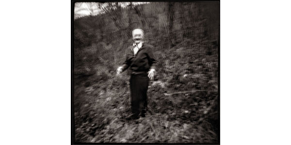 Nancy Rexroth's Emmet Dances the Jig, blurry black and white photograph of an old man dancing in a wooded area