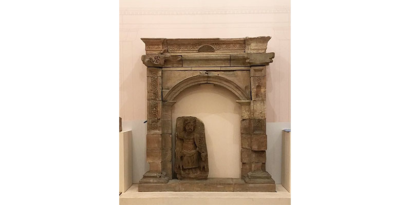 completed archway with stone statue