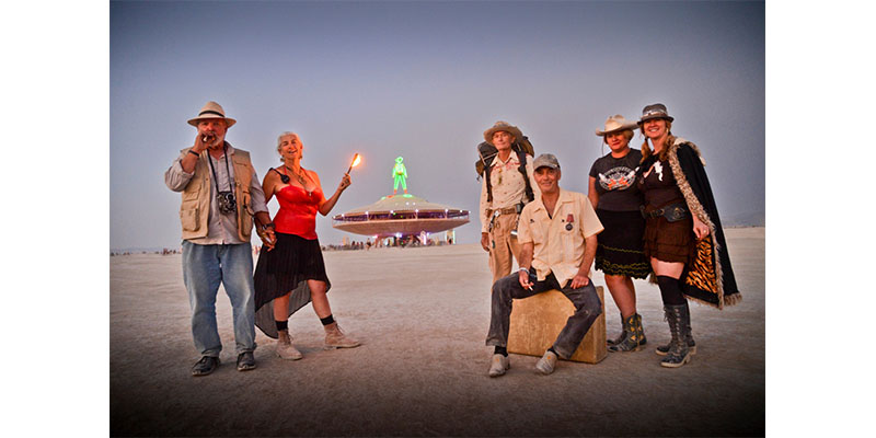 Patrons standing in front of a UFO at Burning Man