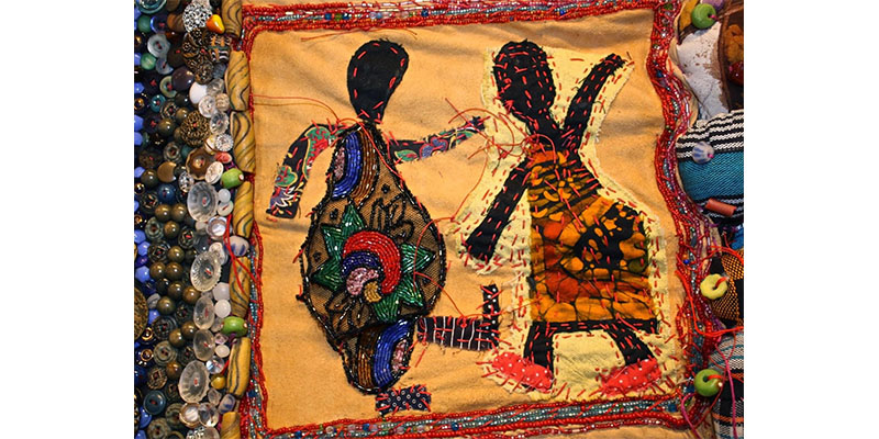 sewn bead work depicting two human figures
