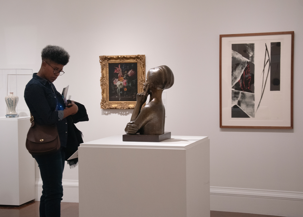 Visitor admires statue of upper half of a woman
