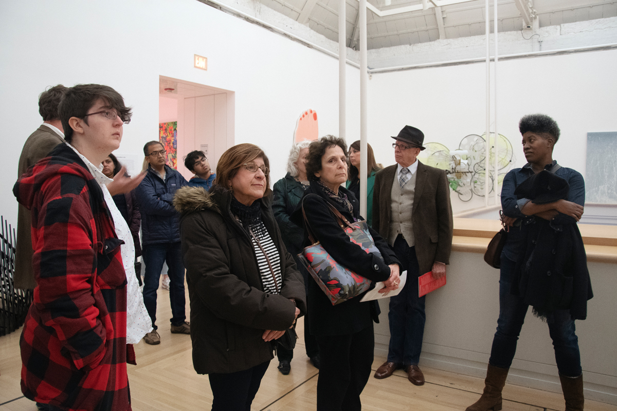 Visitors admire various works in an exhibition