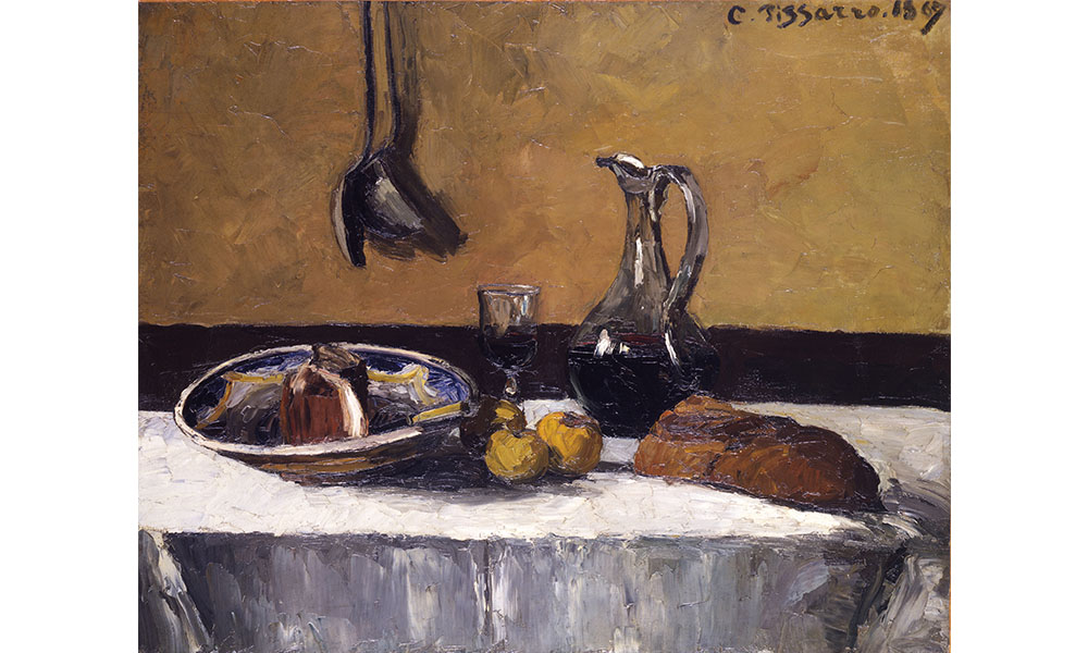 Camille Pissarro's Still Life, painting of a jug of wine, some fruit, and bread sitting on a table in front of a wall where two large spoons hang