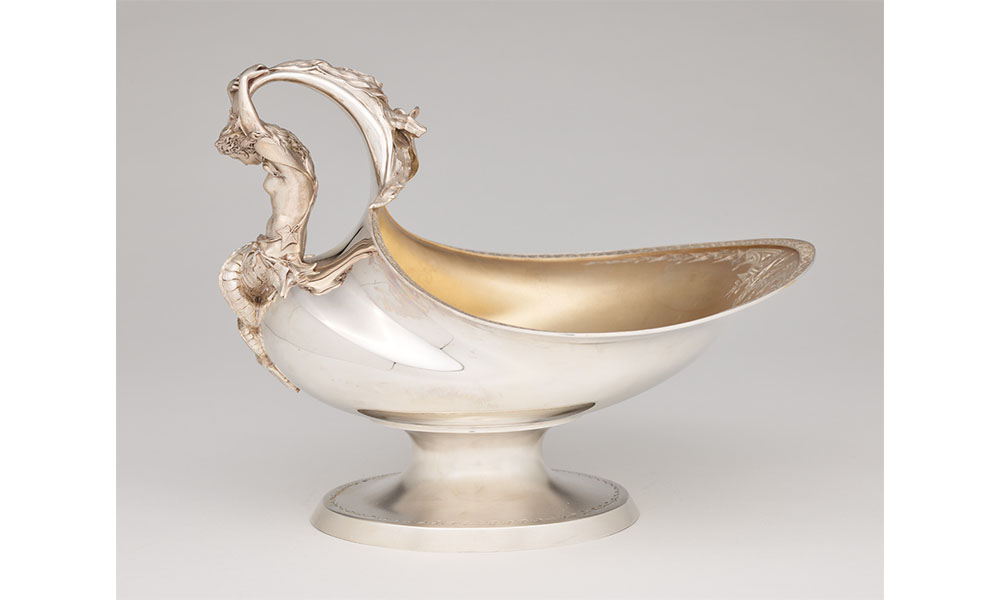 Silver fruit stand with an ornate nude woman for a handle