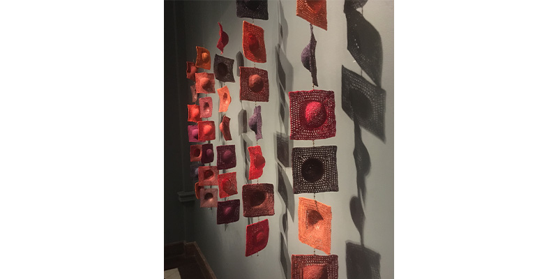 woven swatches of color hung by wire