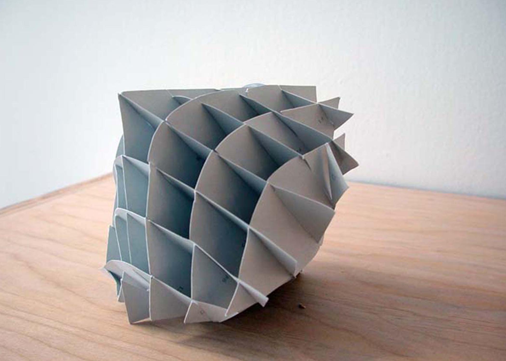 Seong Chun's  Craft-Proof, a large paper sculpture with a round bottom and pointed top, divided into a grid of squares