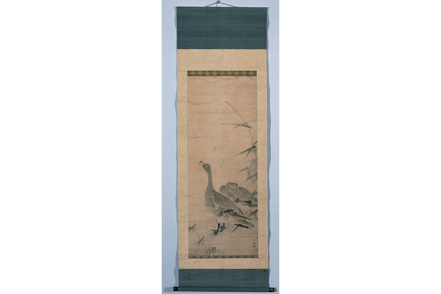 Sesson Shūkei's Wild Geese Calling to the Moon, long rectangular scroll depicting a goose calling upwards towards the sky. Another goose lays sleeping behind the other. 