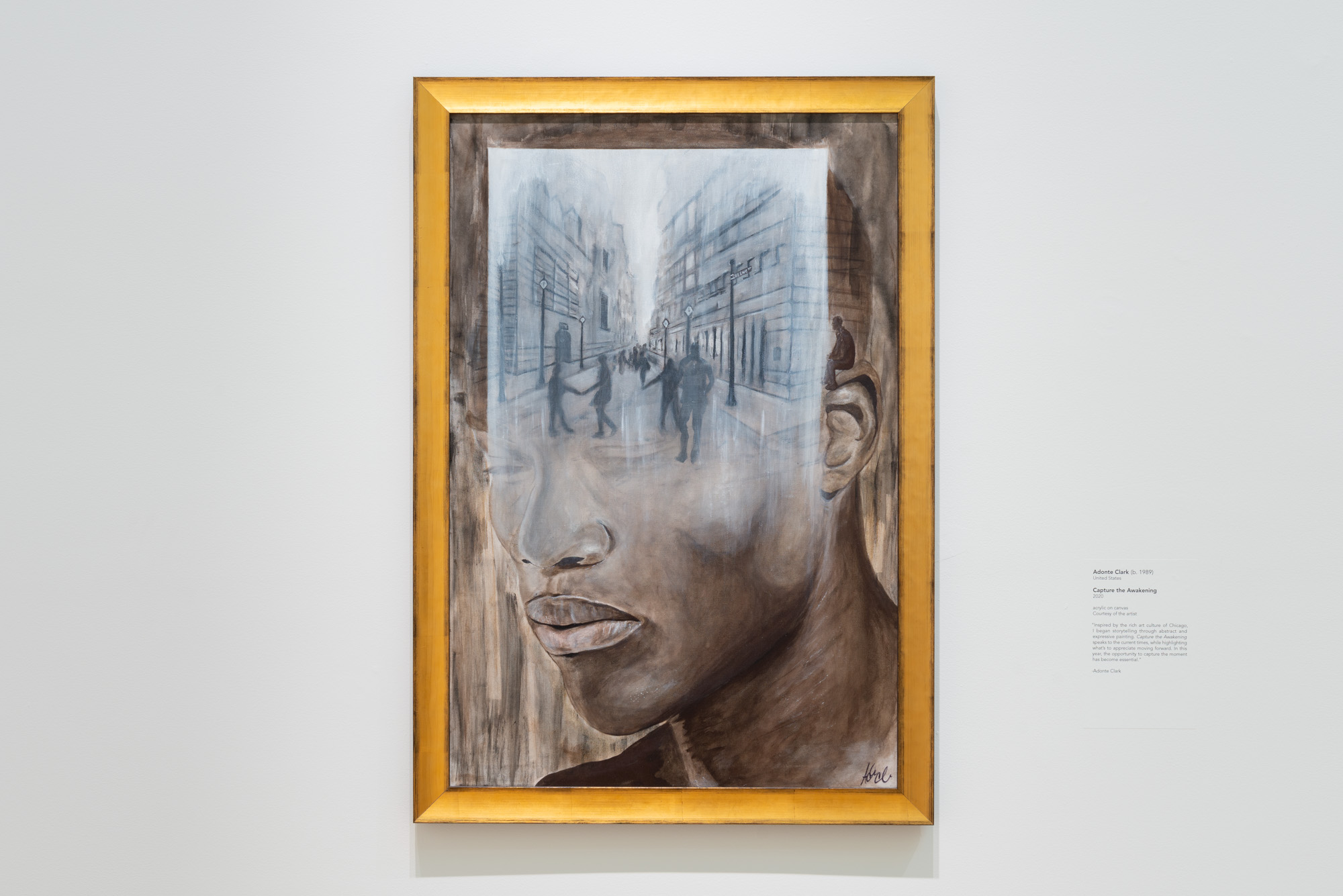 Adonte Clark's Capture the Awakening, a dull grey painting of an African American man's head. A black and white, rectangular scene of silhouettes walking down a city street covers the man's forehead and fades away towards the bottom only slightly obscuring the man's closed eyes