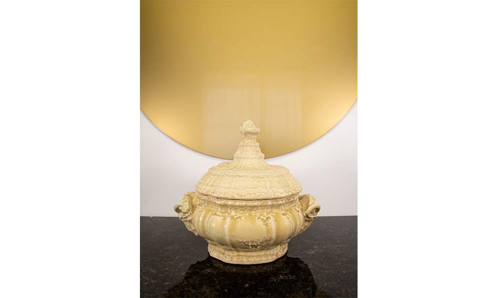 Disk with Tureen, an ornate, yellow, porcelain pot with a tall handled lid