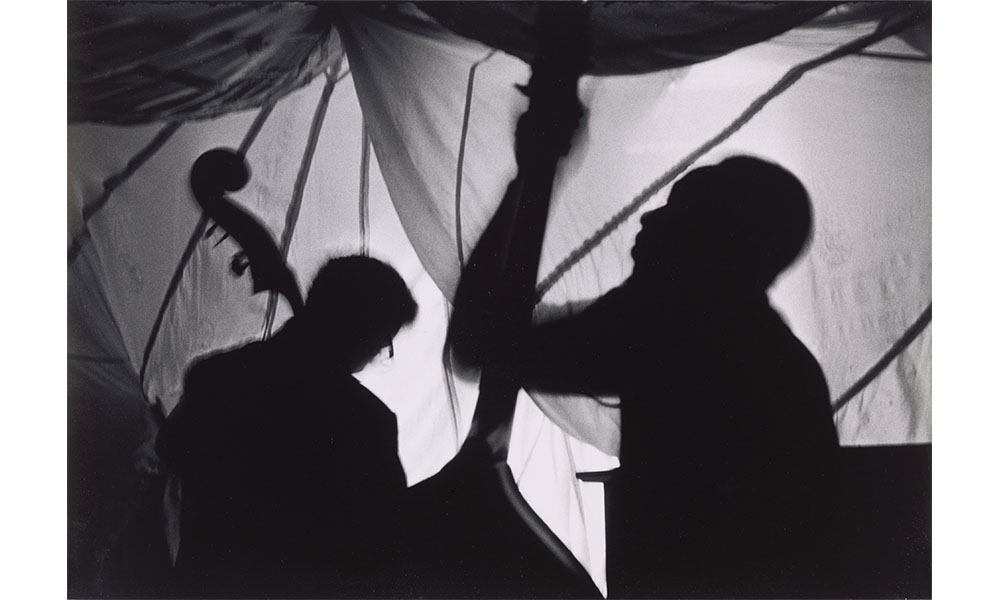 Beuford Smith's Two Bass Hit, black and white photograph of blurry silhouettes of two upright bass players 