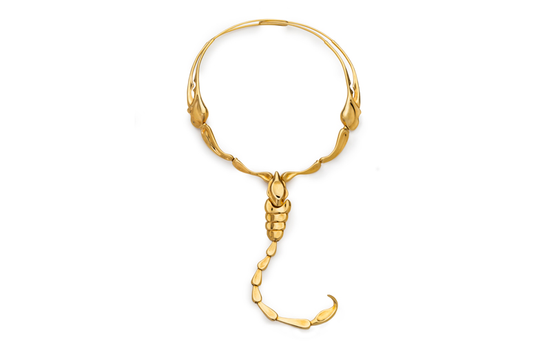 Elsa Pereti's Scorpion Necklace, a gold scorpion whose claws extend upwards and around towards the clasp, the stinger dangles loosely below