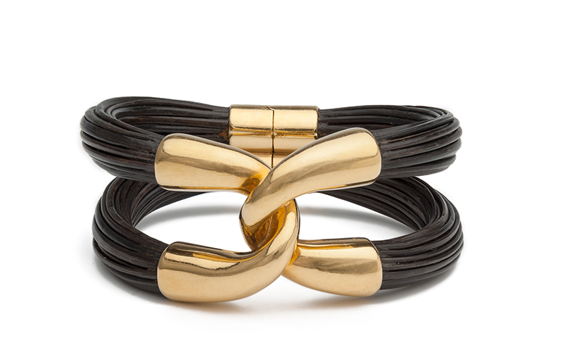 Boucheron's Bracelet, formed from two thick, dark ropes of elephant hair bound by polished yellow gold.