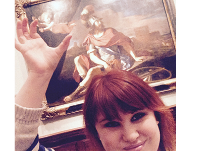 visitor takes a selfie with a painting