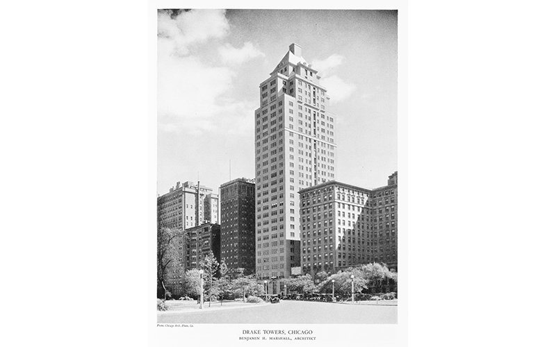 Black and white photograph of Drake Tower, looking up from street-level. 