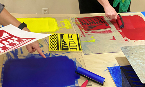 A printmaking workshop with vibrand blue, yellow, and red colors