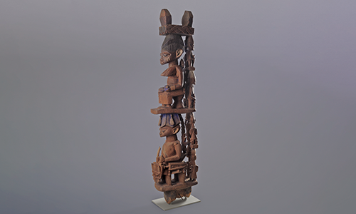 wooden statue with two seated figures