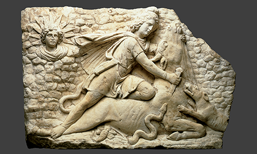 stone carving of a man slaughtering a bull