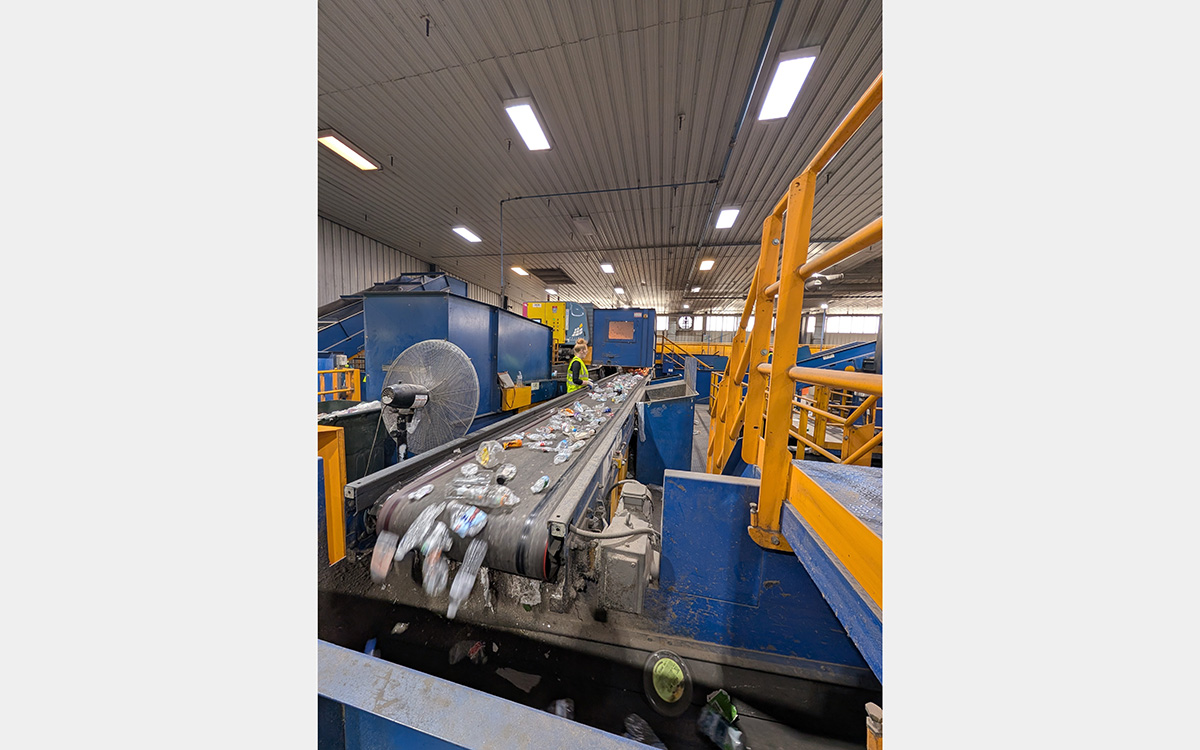 Plastic bottles moving down a conveyor belt