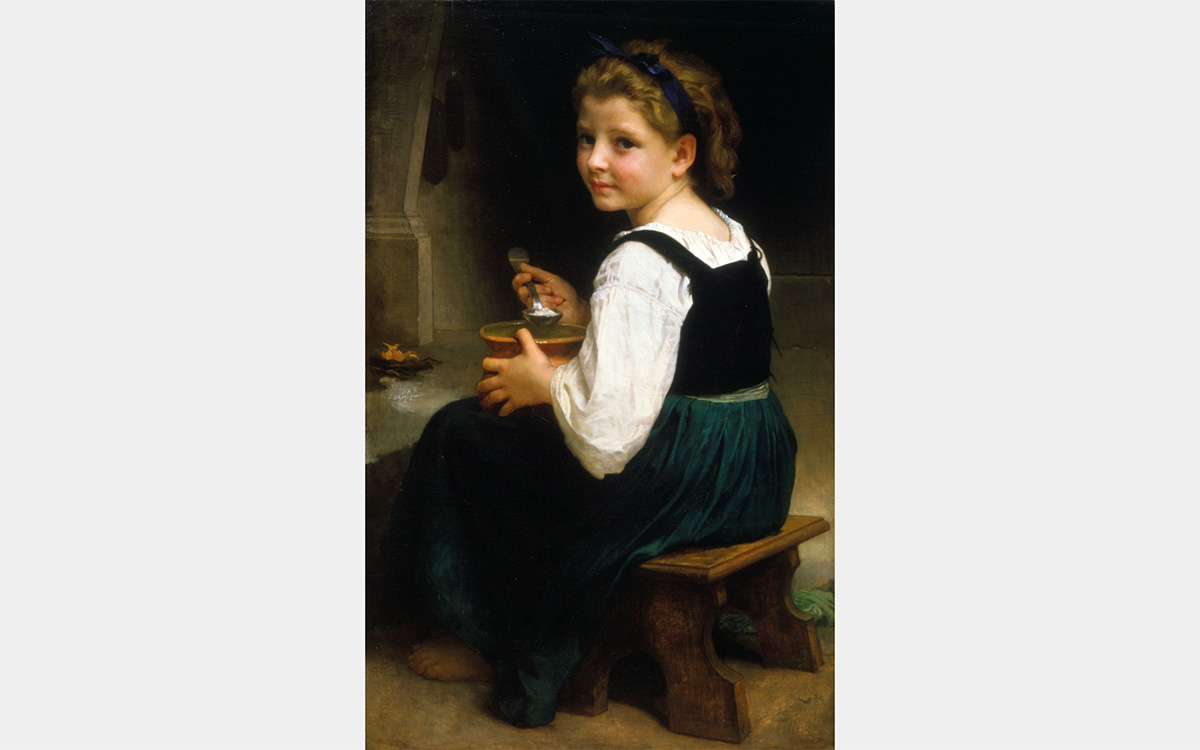 A young white girl looks over her shoulder at the viewer while holding a bowl and spoon.