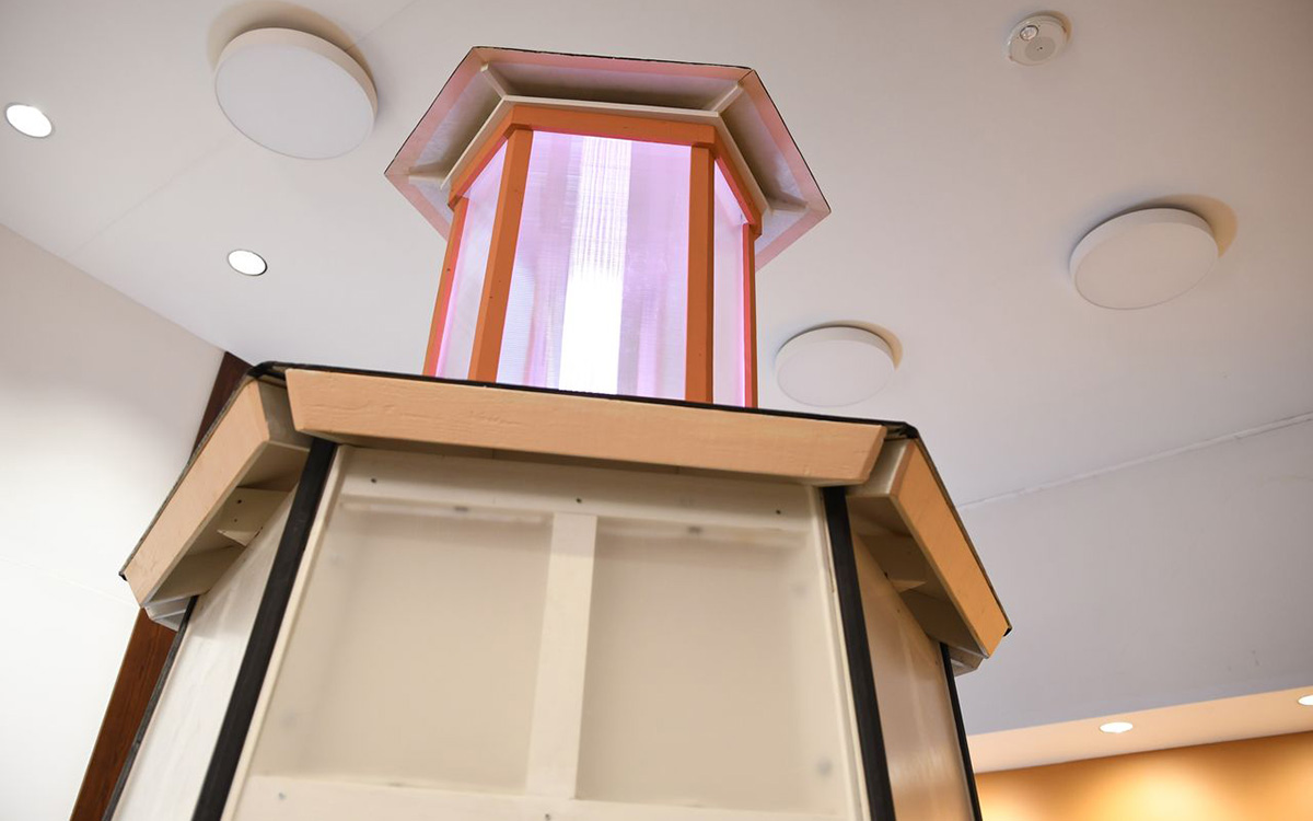 Wood tower-like structure with a lighted beacon on top