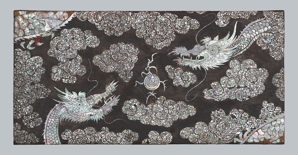 A pearl inlay featuring two dragons swirling in the clouds