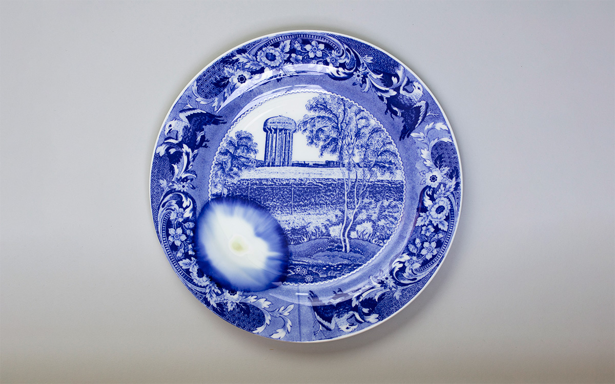 A plate with a blue transfer that has a large melted spot