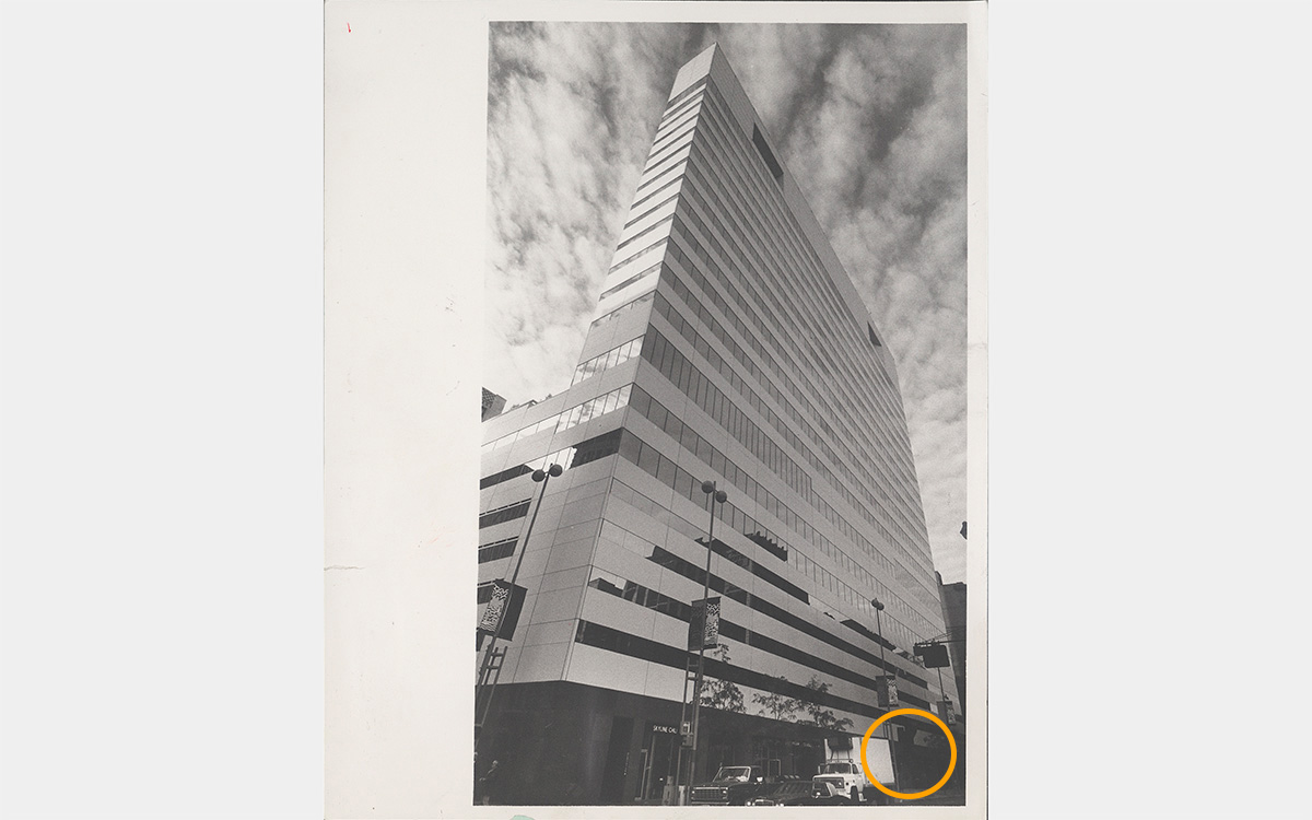 Black and white photo of a skyscraper taken at ground level looking up