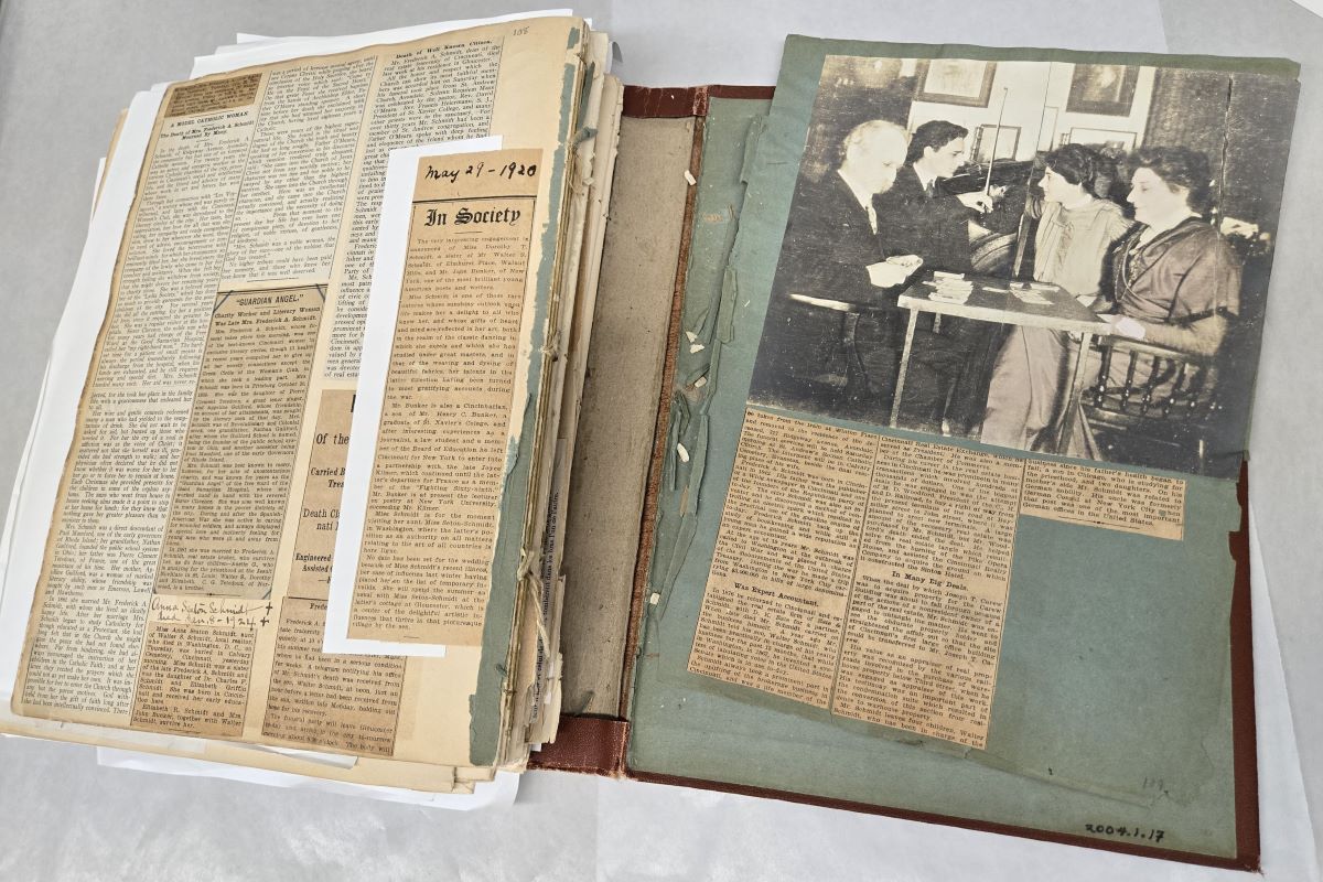 Open scrapbook showing newspaper clippings.