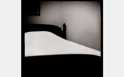 Nancy Rexroth's A Woman's Bed, a black and white photograph of a simple bed