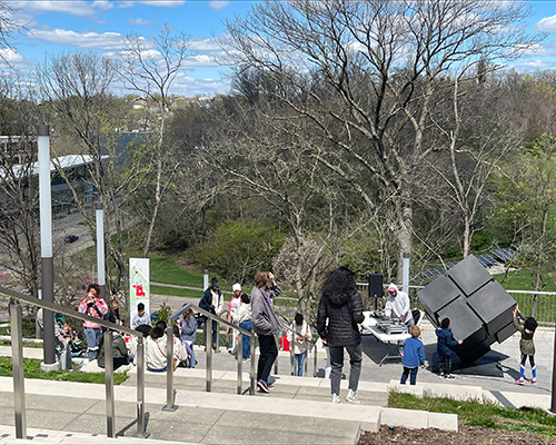 Visitors gather around a sculpture on the Art Climb