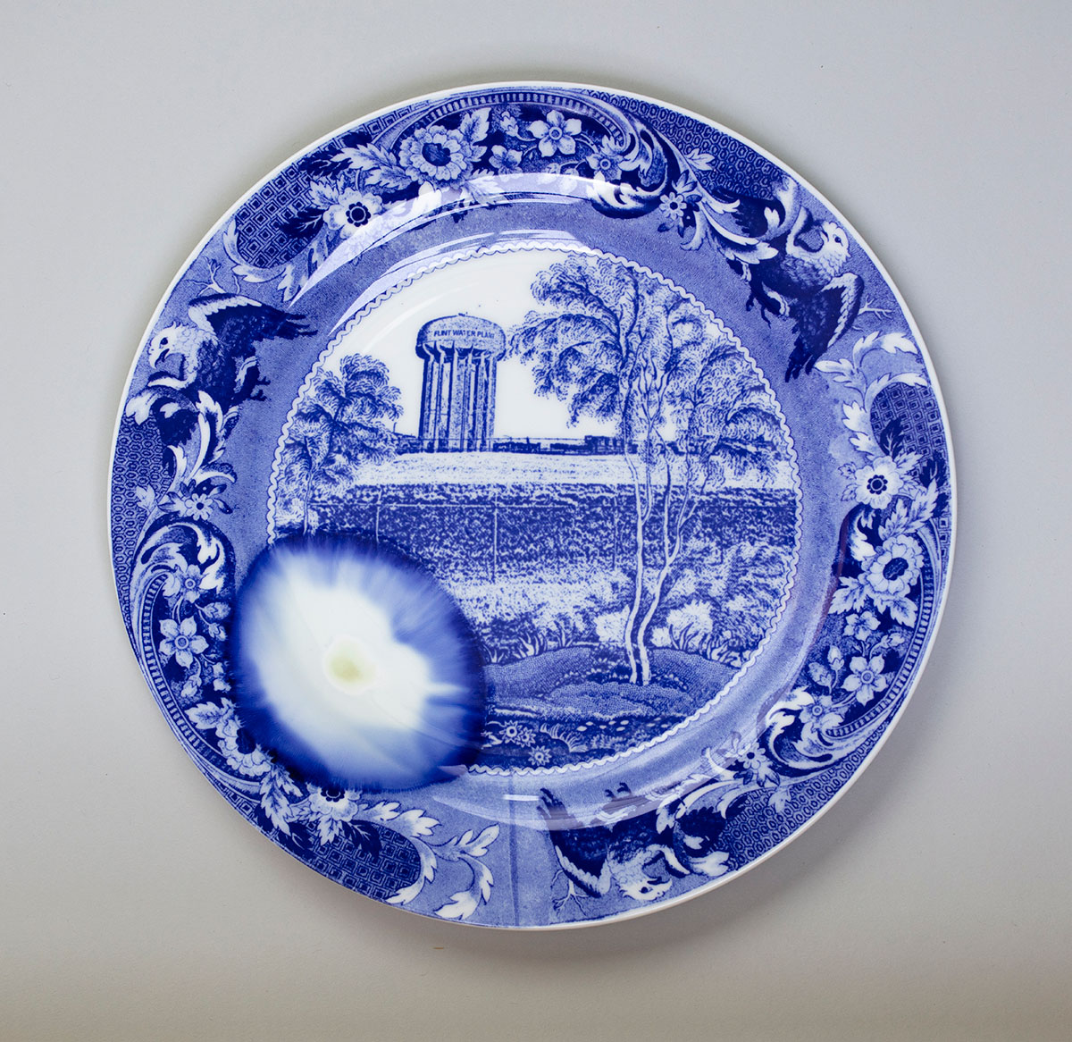 A blue and white plate with a ball on it.