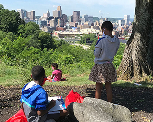 Students sketch the downtown Cincinnati skyline from the museum hillside