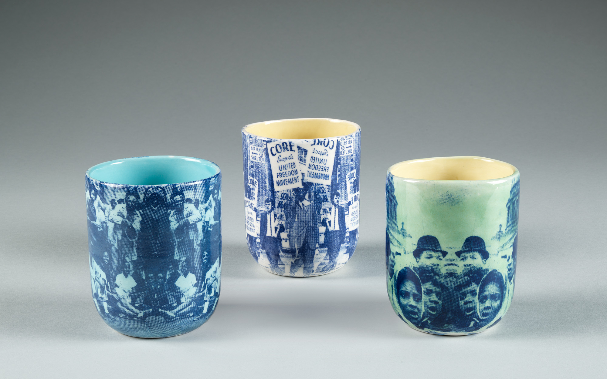 Three cups with prints from racial justice movements