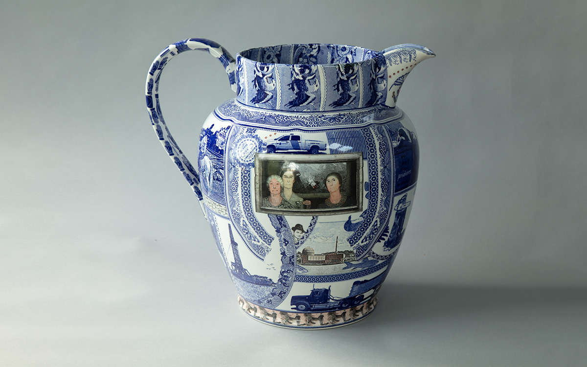 A blue and white transferware jug with an image of three white women