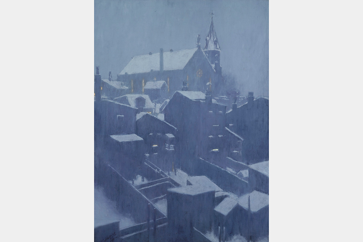Church on a hilltop with houses below, all with snow-covered rooftops