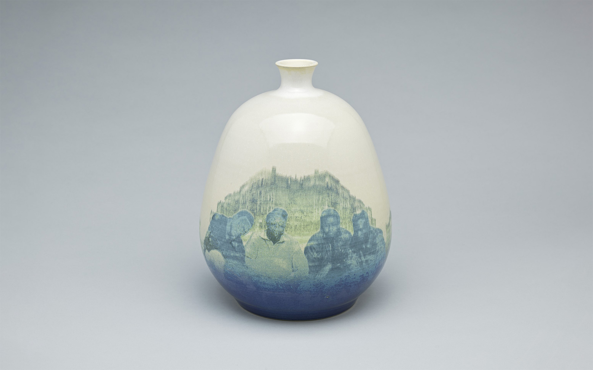 A ceramic vase featuring an image of four Black people in front of a building