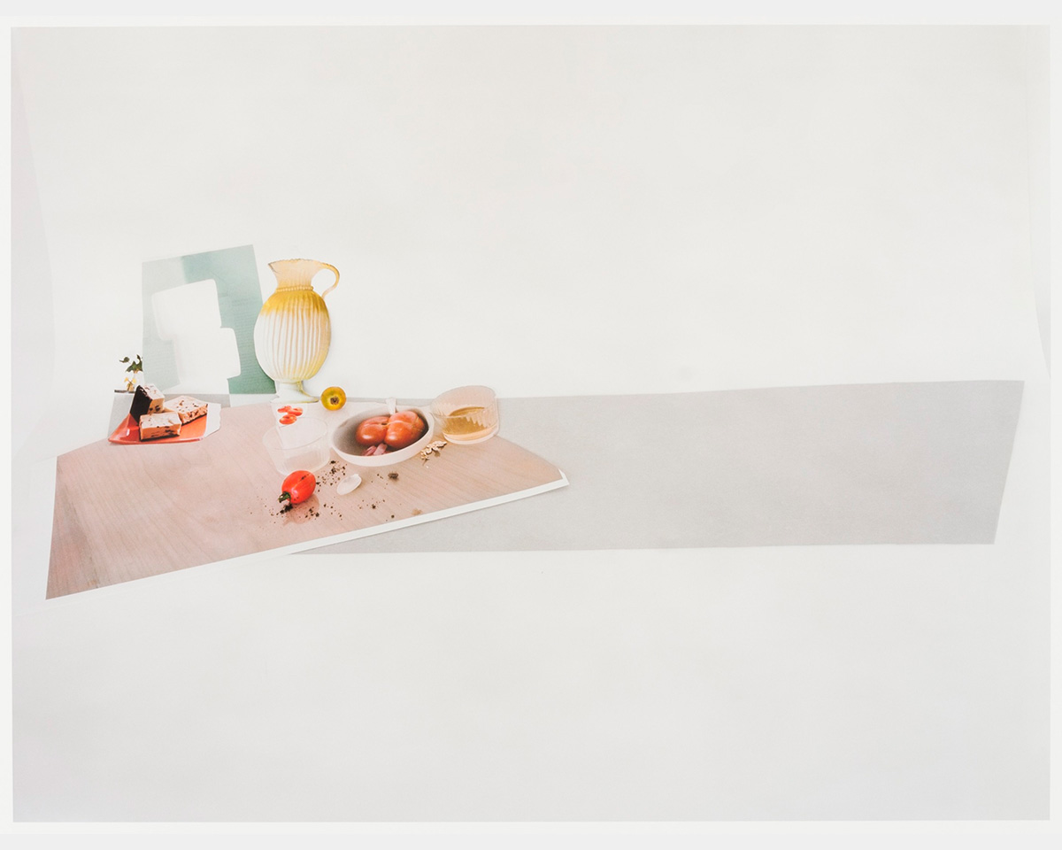 A color photo of a table scene on a grey background